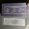 New serpentine belt routing label held next to the faded original on a 2002 Chevrolet Tahoe fan shroud