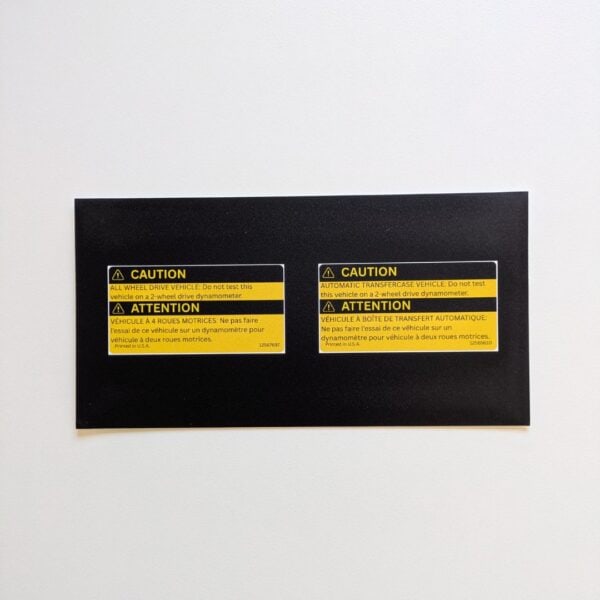 Two-piece GMT Central reproduction set with GM 12565610 transfer case caution and 12567697 AWD warning labels