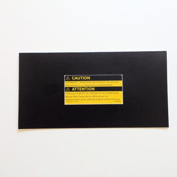 Actual GMT Central reproduction of GM 12565610 bilingual automatic transfer case caution label