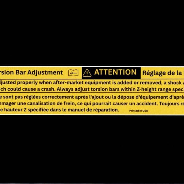 Flat scan of GM 15772975 front torsion bar adjustment warning label reproduction in English and French